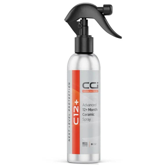 Silver spray bottle with black nozzle on a white background